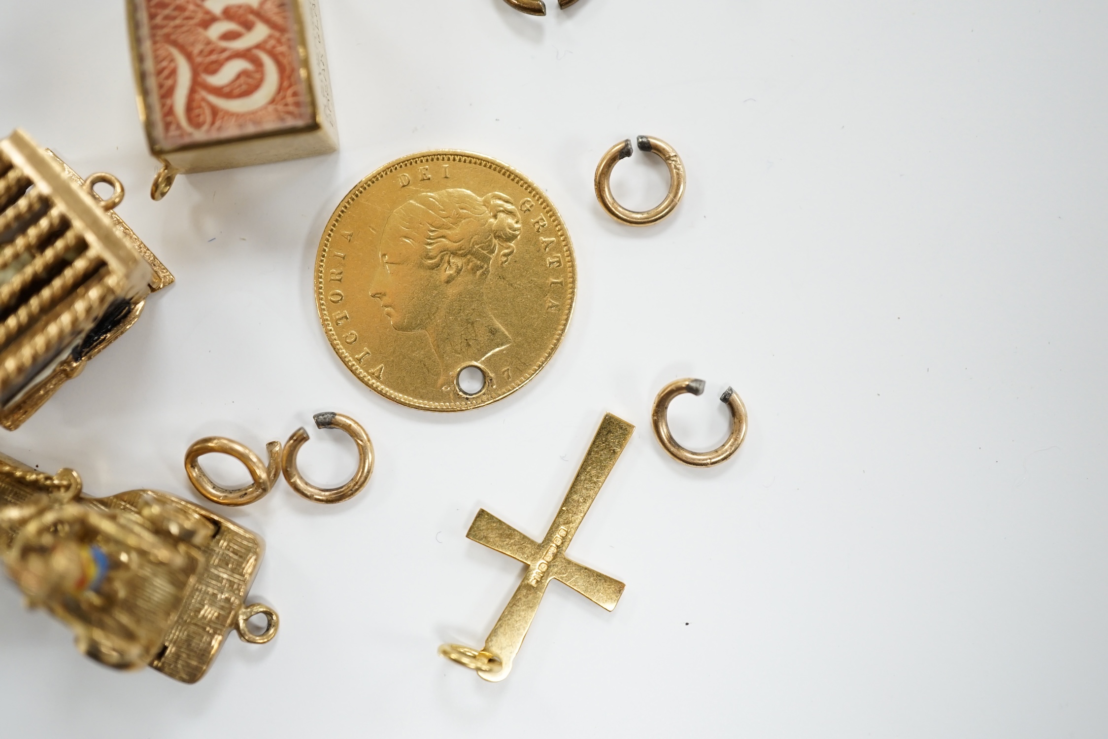 A 9ct gold curb link bracelet and eleven assorted mainly 9ct gold loose charms